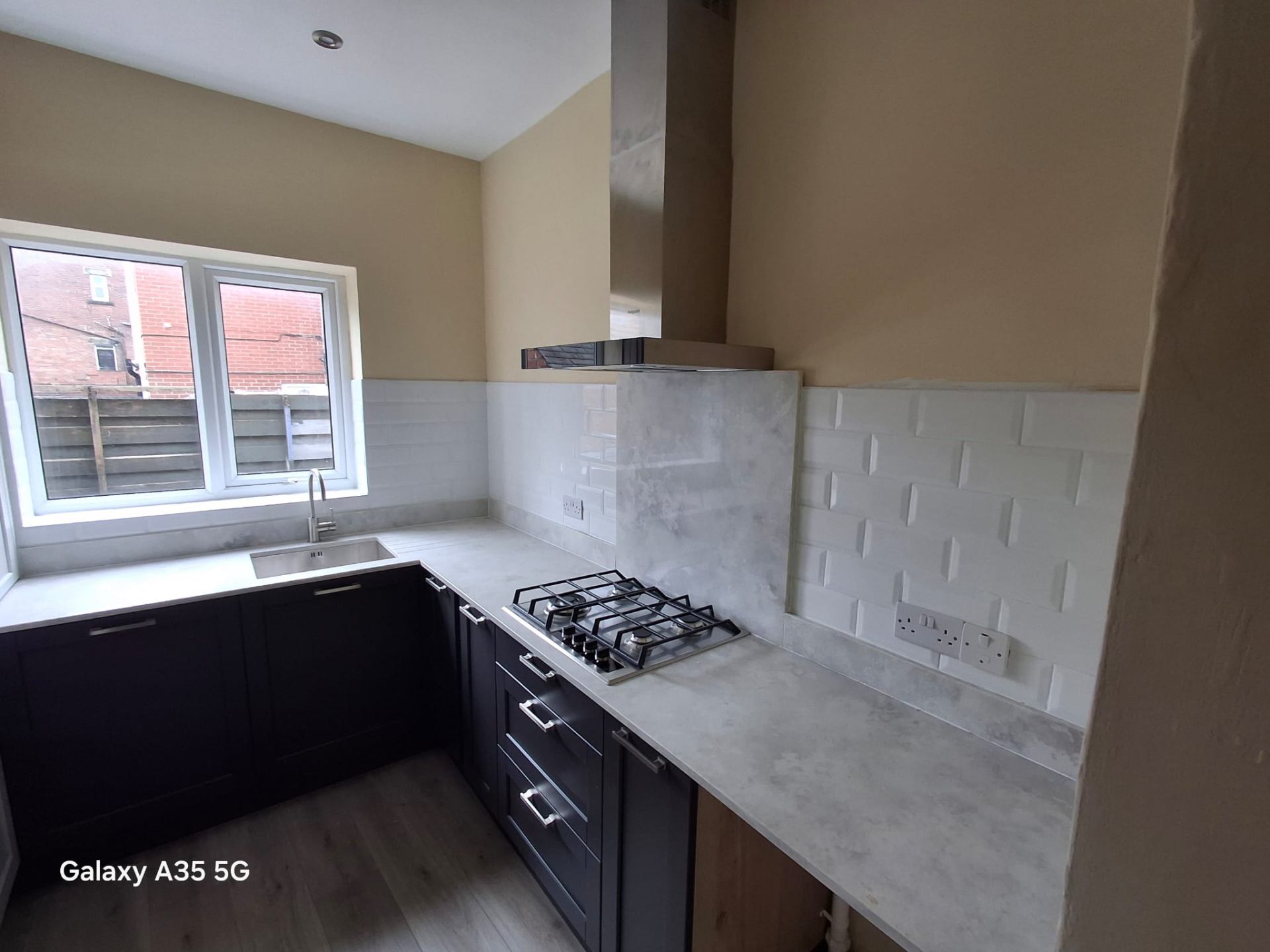 White walk-in bath with curved glass door installed for accessible bathing in a Yorkshire home